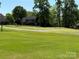 Scenic view of the home backing onto a lush green golf course at 6144 Abergele Ln, Matthews, NC 28104