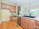 Efficient kitchen with stainless steel dishwasher and built-in desk at 6144 Abergele Ln, Matthews, NC 28104