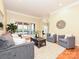 Bright living room featuring a stylish sofa, chairs, hardwood floors, and access to the porch at 6144 Abergele Ln, Matthews, NC 28104