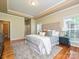 Main bedroom features a tray ceiling, plush carpet, and natural light from the many windows at 6144 Abergele Ln, Matthews, NC 28104