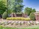 Welcoming Shannamara neighborhood entrance with brick sign, flower beds, and landscaping at 6144 Abergele Ln, Matthews, NC 28104