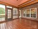 Spacious screened-in porch with wood flooring and brick accents, great for outdoor enjoyment at 6144 Abergele Ln, Matthews, NC 28104