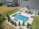 Aerial view of stunning pool, deck, landscaping, and surrounding homes at 6529 Jepson Ct, Charlotte, NC 28214