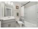 Cozy bathroom with a vanity, toilet, tub, and shower with modern fixtures at 6529 Jepson Ct, Charlotte, NC 28214