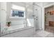 Bright bathroom features tub and shower separated by glass wall with a view into a closet at 6529 Jepson Ct, Charlotte, NC 28214