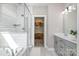 Elegant bathroom with a soaking tub, glass shower, and stylish vanity at 6529 Jepson Ct, Charlotte, NC 28214