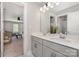Modern bathroom with double vanity, white countertops, and view into another room at 6529 Jepson Ct, Charlotte, NC 28214