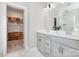 Elegant bathroom with double vanity, modern fixtures, and view to storage room at 6529 Jepson Ct, Charlotte, NC 28214