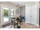 Cozy dining area with a round table, modern light fixture, and access to the outdoor pool area at 6529 Jepson Ct, Charlotte, NC 28214