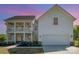 Charming two-story home featuring a double front porch, attached garage, and a beautifully landscaped front yard at 6529 Jepson Ct, Charlotte, NC 28214