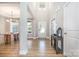 Bright foyer featuring hardwood floors, high ceilings, and an open view into the adjacent dining area at 6529 Jepson Ct, Charlotte, NC 28214
