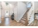Inviting foyer with wood floors, staircase, and elegant decor, providing a warm welcome into the home at 6529 Jepson Ct, Charlotte, NC 28214