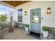 Cozy front porch with stylish seating, elegant lighting, and a welcoming entrance featuring a beautifully painted door at 6529 Jepson Ct, Charlotte, NC 28214