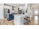 Modern kitchen with white cabinets, blue island, stainless steel appliances, and quartz countertops at 6529 Jepson Ct, Charlotte, NC 28214