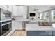 Modern kitchen and living room with an open floor plan with a large kitchen island and stainless steel appliances at 6529 Jepson Ct, Charlotte, NC 28214