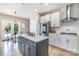 Kitchen featuring quartz island with seating, stainless steel appliances and view to an outdoor dining area at 6529 Jepson Ct, Charlotte, NC 28214