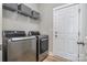 Laundry room with modern washer and dryer, and a door leading to another area at 6529 Jepson Ct, Charlotte, NC 28214