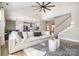Open-concept living room with vaulted ceilings, a fireplace, and seamless flow to the kitchen and staircase at 6529 Jepson Ct, Charlotte, NC 28214