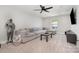 Cozy living room with a large sectional sofa, ceiling fan, and natural light from window at 6529 Jepson Ct, Charlotte, NC 28214