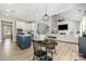 Spacious open-concept living area with a kitchen island, dining area, and a view of the living room with fireplace at 6529 Jepson Ct, Charlotte, NC 28214