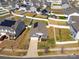 Aerial shot of a neighborhood featuring well-manicured lawns, fenced yards, and solar panels on the roofs at 6816 Pennyroyal Way, Charlotte, NC 28216
