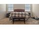 Neutral bedroom with two windows and a comfortable bed covered in a quilt at 6816 Pennyroyal Way, Charlotte, NC 28216
