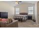 Neutral bedroom with two windows, carpeted floor and wooden furnishings at 6816 Pennyroyal Way, Charlotte, NC 28216