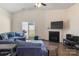 Cozy living room with vaulted ceiling, fireplace, and sliding door access to backyard at 6816 Pennyroyal Way, Charlotte, NC 28216