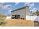 The backyard features a patio area with furniture, a small garden, and a white privacy fence at 715 Saddlebred Ln, Locust, NC 28097