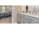 Bathroom featuring double vanity and modern fixtures, conveniently located near a bedroom with carpet flooring at 715 Saddlebred Ln, Locust, NC 28097