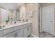 Bathroom with a double sink vanity, white cabinets, and a large framed mirror at 715 Saddlebred Ln, Locust, NC 28097