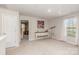 Bonus room with a bright window, complemented by neutral carpet and a small decorative table at 715 Saddlebred Ln, Locust, NC 28097