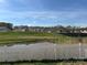 Scenic view of a pond and green space in a residential community with homes on a hill at 715 Saddlebred Ln, Locust, NC 28097