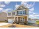 Inviting two-story home with stone facade, well-manicured landscaping, and a welcoming entrance at 715 Saddlebred Ln, Locust, NC 28097