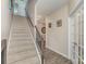 Hallway with stairs, wood-look floors, neutral walls, and a white-framed glass door at 715 Saddlebred Ln, Locust, NC 28097