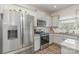 Bright eat-in kitchen featuring stainless steel appliances, light gray cabinets, and granite countertops at 715 Saddlebred Ln, Locust, NC 28097