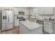 Updated kitchen boasts stainless steel appliances, granite countertops, and a center island at 715 Saddlebred Ln, Locust, NC 28097