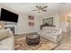Cozy living room with fireplace, ceiling fan, plush furniture, and stylish decor at 715 Saddlebred Ln, Locust, NC 28097