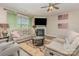 Comfortable living room featuring plush seating, a fireplace, a ceiling fan, and natural light at 715 Saddlebred Ln, Locust, NC 28097