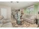 Spacious living room with modern furnishings, a view into the kitchen, and lots of natural light at 715 Saddlebred Ln, Locust, NC 28097