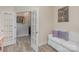 Living room with wood-look floors and open French doors leading to the hallway at 715 Saddlebred Ln, Locust, NC 28097
