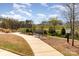 Enjoy the community walking trails and scenic green spaces with a bench for relaxing and enjoying the view at 715 Saddlebred Ln, Locust, NC 28097