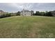 Expansive backyard with lush green grass, a patio, and plenty of space for activities at 8011 Caliterra Dr, Charlotte, NC 28227