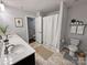 Bathroom featuring double sinks, a neutral color scheme, and a shower/tub combo with a curtain at 8011 Caliterra Dr, Charlotte, NC 28227