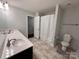 Bathroom featuring double sinks, a neutral color scheme, and a shower/tub combo with a curtain at 8011 Caliterra Dr, Charlotte, NC 28227