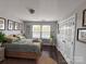 Well-lit bedroom featuring dark wood floors, warm decor, and natural light at 8011 Caliterra Dr, Charlotte, NC 28227