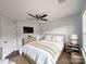 Bright bedroom with a ceiling fan, mounted TV, and neutral decor for a relaxing retreat at 8011 Caliterra Dr, Charlotte, NC 28227
