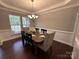 Traditional dining room showcasing wainscoting, neutral colors, and seating for six at 8011 Caliterra Dr, Charlotte, NC 28227
