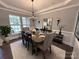 Traditional dining room featuring wainscoting, a tray ceiling, and a table set for six at 8011 Caliterra Dr, Charlotte, NC 28227
