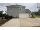 Two-story home with a large garage and a well-maintained driveway at 8011 Caliterra Dr, Charlotte, NC 28227